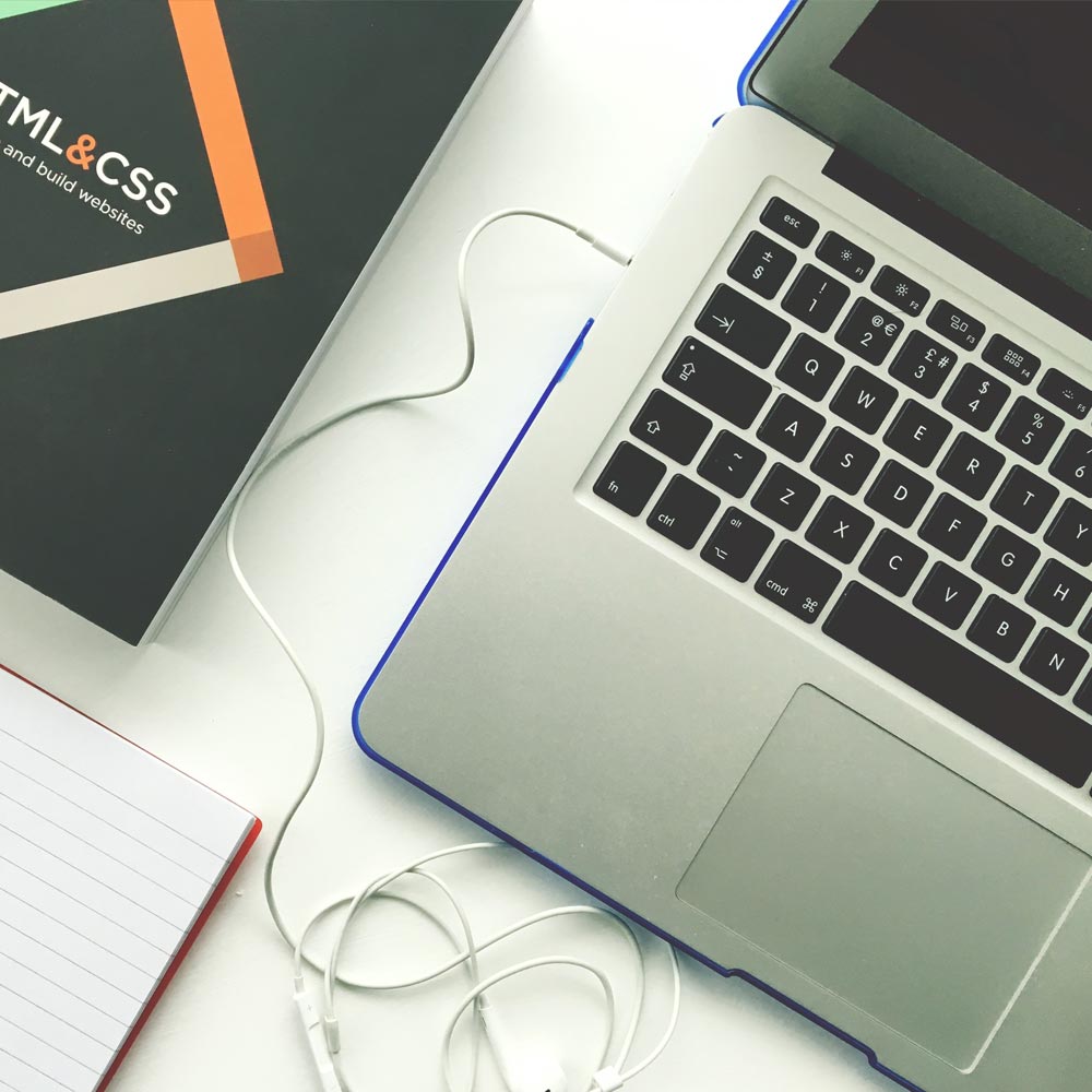 Desk with book and MacBook